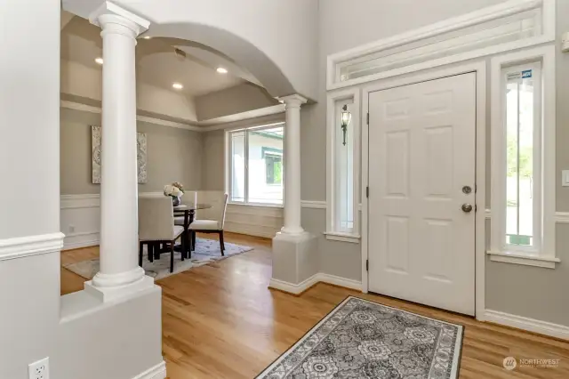 This view facing the front door showcases the formal dining room across from the formal living room. Recessed ceiling and canned lights with yet another large window offering an abundance of natural light.