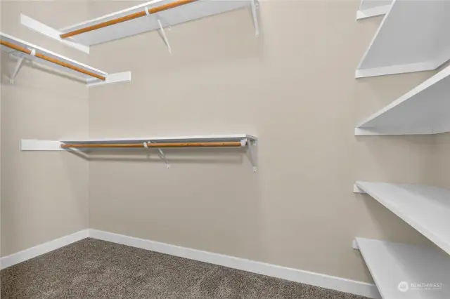 Walk-in-closet for primary bedroom. Solid shelving in all closets. Photo for illustration only, not actual