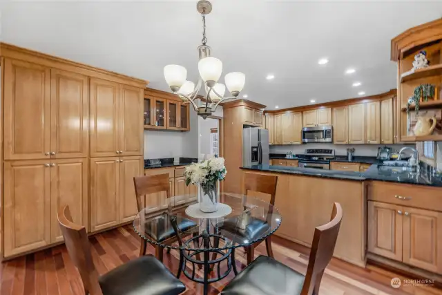 Eat in space near kitchen showcases the extensive pantry cupboard wall, coffee station, and spacious kitchen.