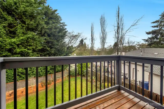 Primary Suite offers a private deck for enjoying the fresh air, and potentially catching some sunset colors across that sky.