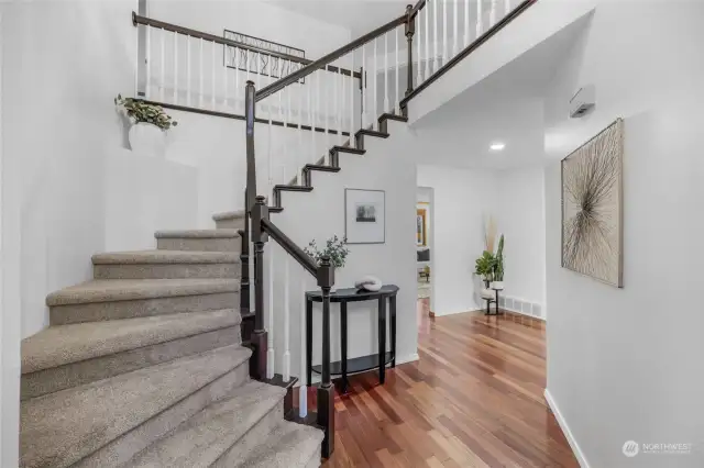 Front foyer welcomes you with dramatic staircase and entry to formal areas, as well as to family room and office.