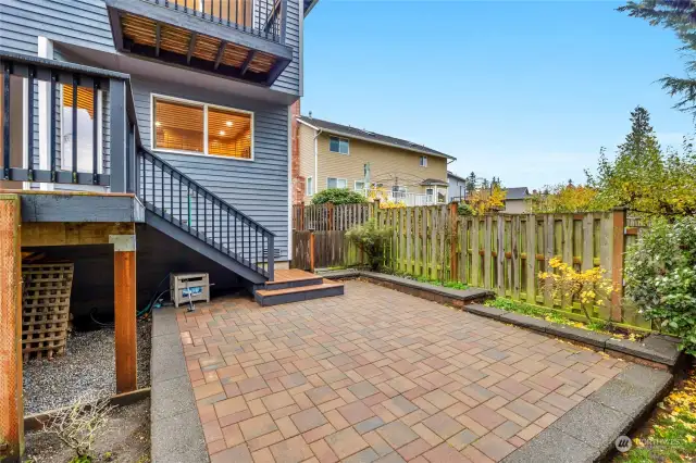 Lower Patio in back yard.  On right side is gate to dog run, or potential gated garden area.