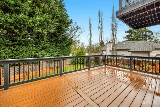 Low maintenance decking offers you a lovely place to enjoy the beautiful back yard area.