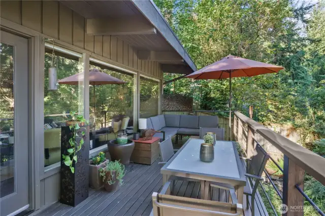 Expansive deck seamlessly extends living space into nature with covered & open-air areas.