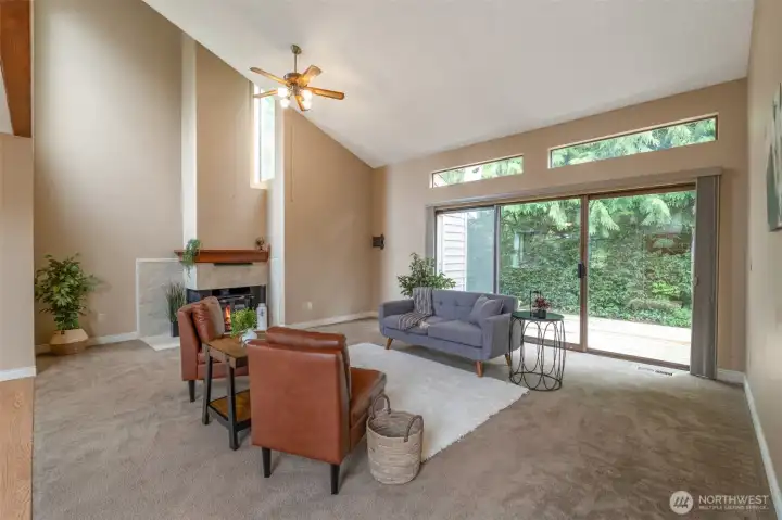 Warm up by the fireplace or step out through the slider to your private deck with peaceful nature views.