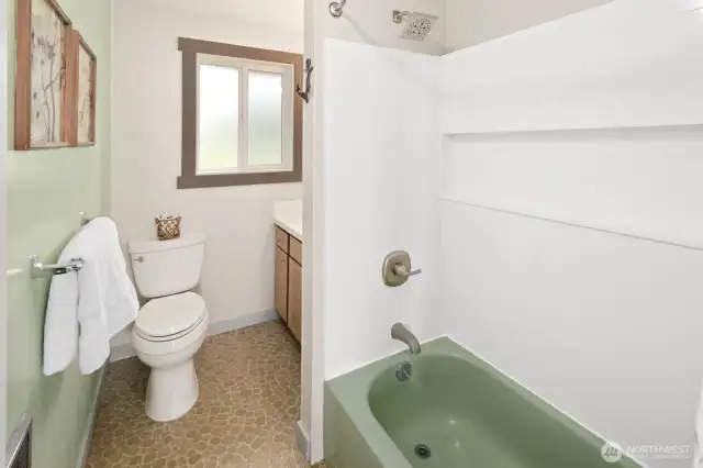 Bathroom with updated shower surround and vanity sink.