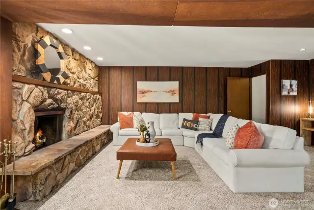 Downstairs features a huge rec room with a super cool retro stone fireplace!