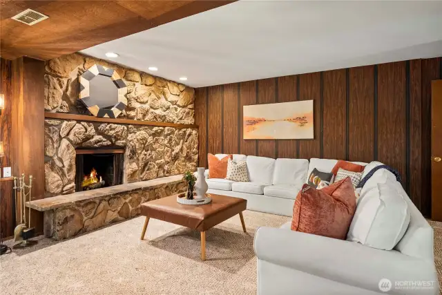 Large accent stone fireplace would look fantastic with some more modern touches throughout this rec room area.
