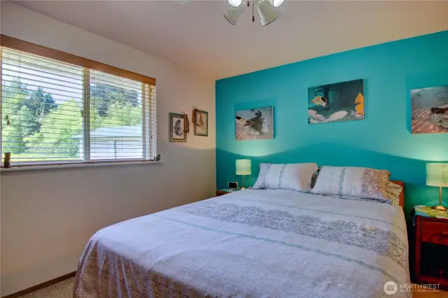 Primary bedroom with large window to bring in the natural light