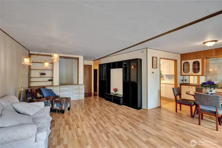 Open floor plan with living room with dining area. Large windows bring in a lot of light.