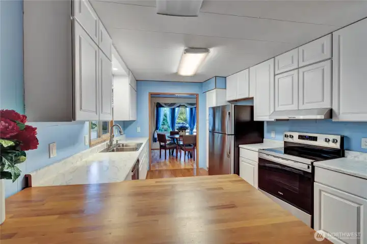 Beautiful kitchen with new countertops, new sink & faucet & newer stainless steel appliances.