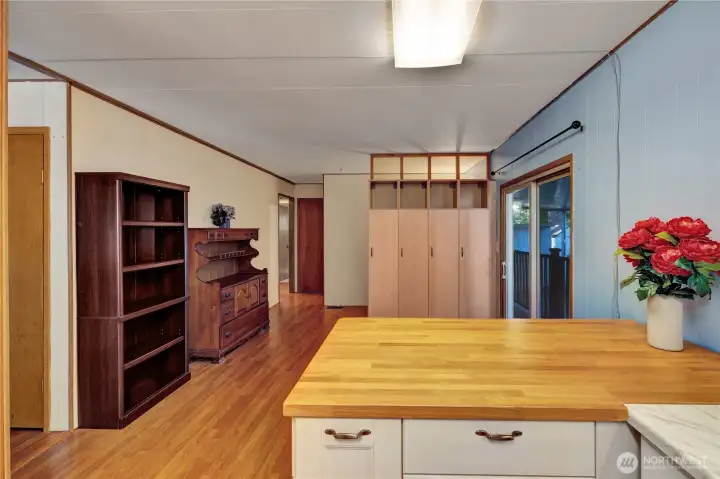 The kitchen has an eating area that opens to the family room. A room divider provides a dual uses in the family room.