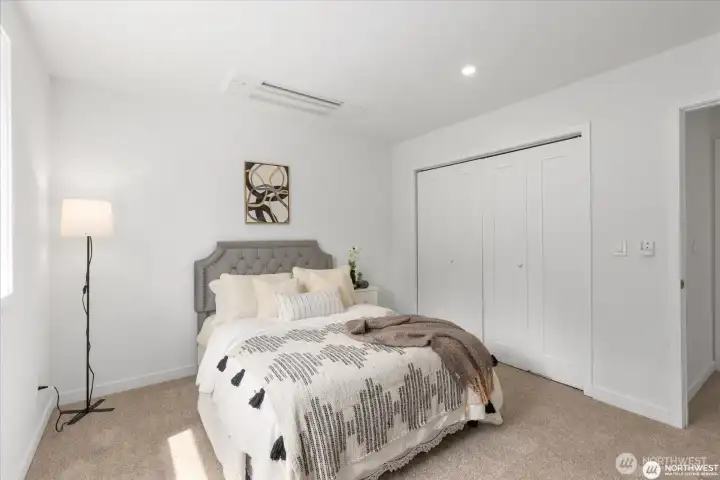 2nd bedroom view from inside corner, showing closet and entry door.