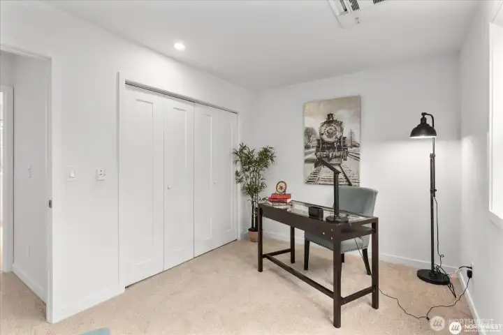 View of 3rd bedroom looking towards entry door and closets.
