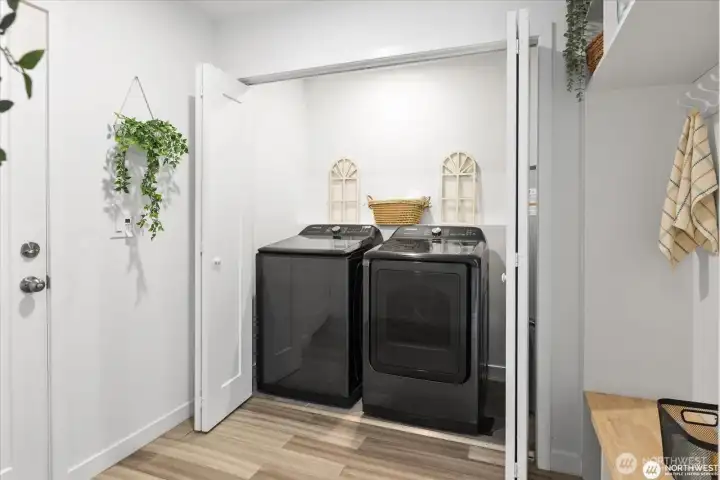 Utility room with newer washer/dryer (both convey) as well as a large folding/hanging/storage space.