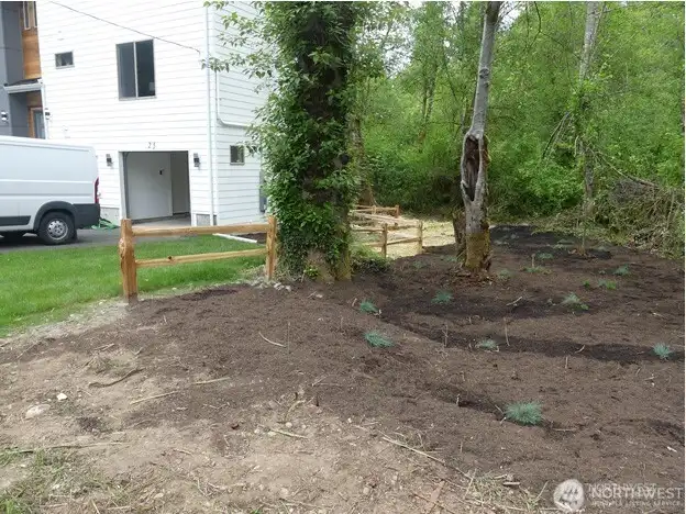 Virtual photo of west side of house after landscaping and split rail work to be completed by seller.