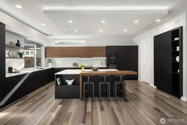 The chef's kitchen is designed for creating culinary magic with it's high-end appliances and adjacent spice kitchen.