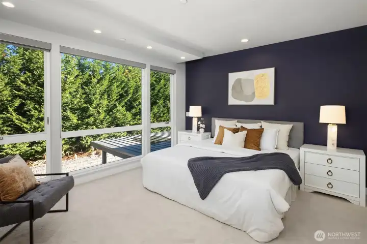 The private primary bedroom features floor to ceiling windows that perfectly light up the room.