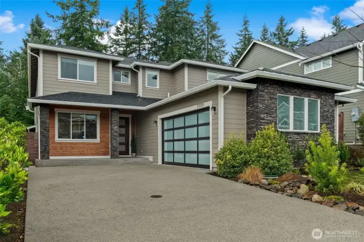 Level driveway leading up to this gorgeous two-car attached garage.