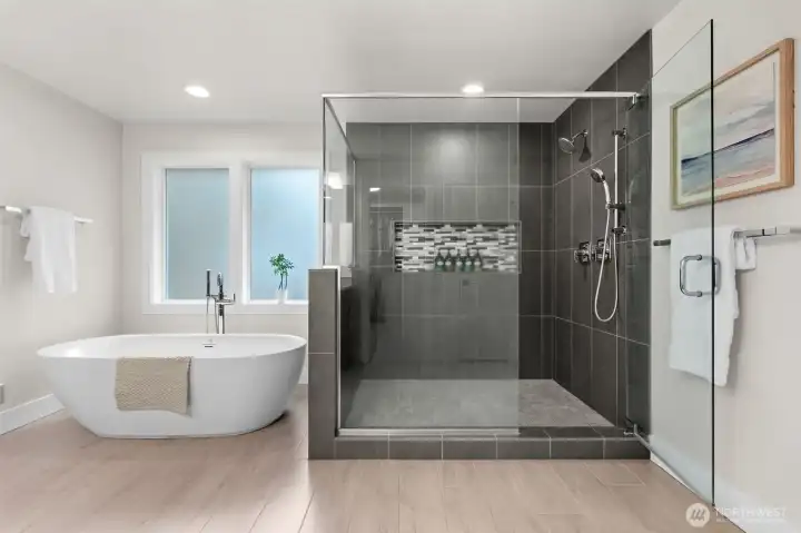 This gorgeous bathroom is comprised of a stunning free standing tub and an attractive tiled shower.