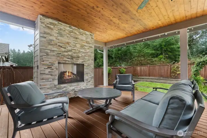 Enjoy your own covered patio in any weather with it's built-in gas fireplace and hanging ceiling fan.