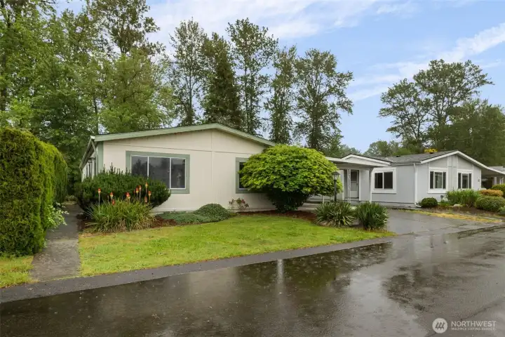 Attractive home with mature landscaping and convenient covered carport in the desirable Mountain View Estates 55+ community.