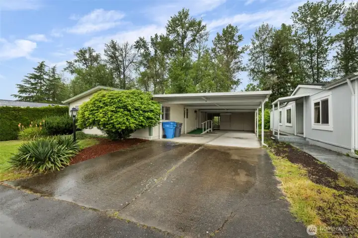 Large covered carport with attached shop and storage area—perfect for projects, hobbies, and extra storage.