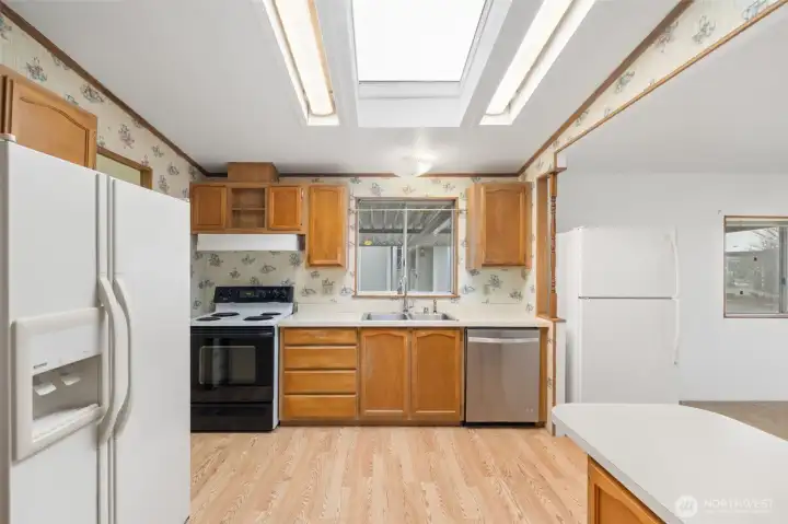 Well-equipped kitchen offering plenty of cabinet storage, full appliance package, and ample prep space.