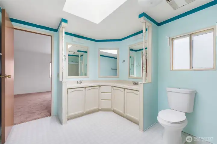 Spacious primary bathroom featuring double sinks, ample counter space, and abundant natural light.