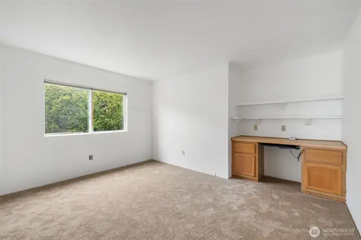 Den offers built-in desk offering a convenient workspace for office or hobby use.