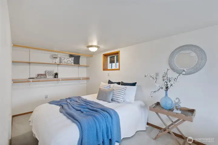 Lower level bedroom with views out the front yard...window not pictured here.