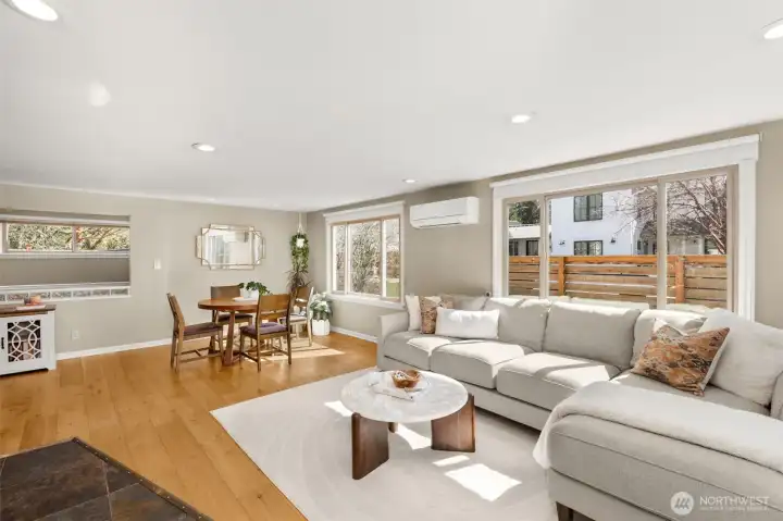 Open spacious living room offers options for room placement! Complete with hardwood flooring, updated windows that bring in abundant natural light and a convenient slate floor entry for those rainy days.