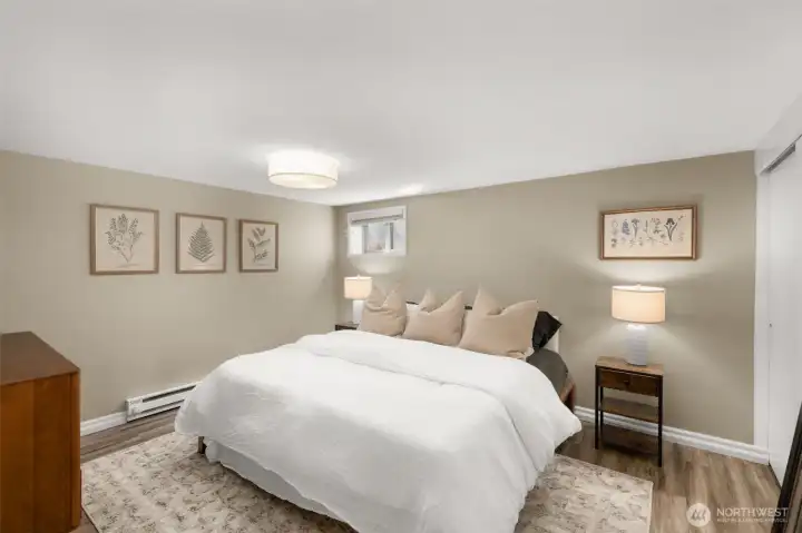 Primary Bedroom on the lower level features an oversized walk-in closet, LVP flooring and fresh paint.