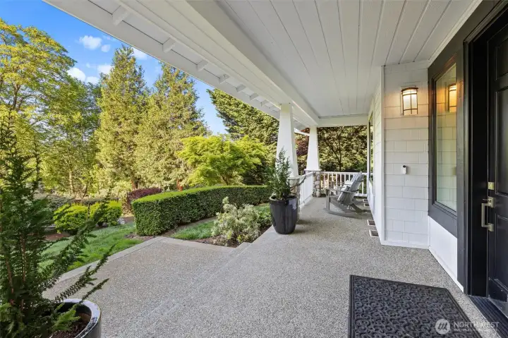 Peaceful covered front porch overlooking the large grassy front yard.