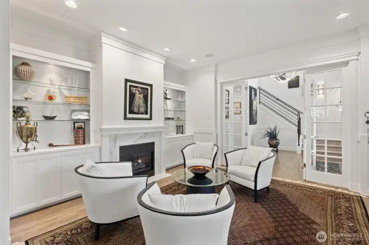 Formal living room with glass French doors and gas fireplace.