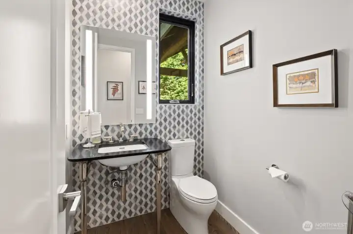 Cute powder room downstairs with low-flow toilet.