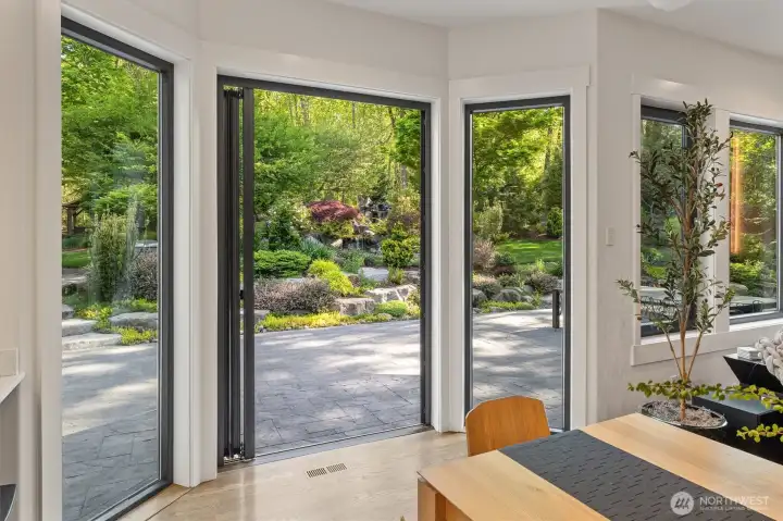 Enjoy indoor-outdoor living with this beautiful NanaWall off the second dining room. Notice the view of the water feature!