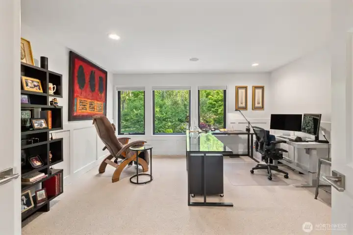 Large office space at the top of the stairs offers an incredible view of the private backyard.