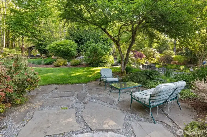 One of multiple seating and entertaining areas meandering through the backyard.