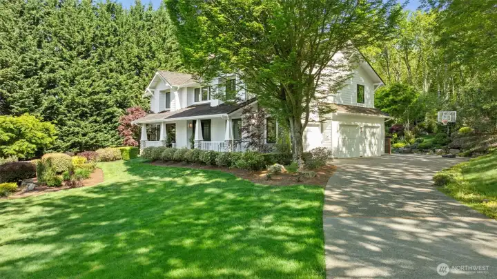 Oversized three-car garage has EV charger and storage room. Enjoy the idyllic winding driveway.