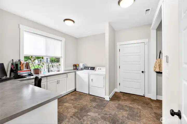 This is a full service mudroom/laundry room with a storage knook. This is a full service mudroom/laundry room with a storage knook.