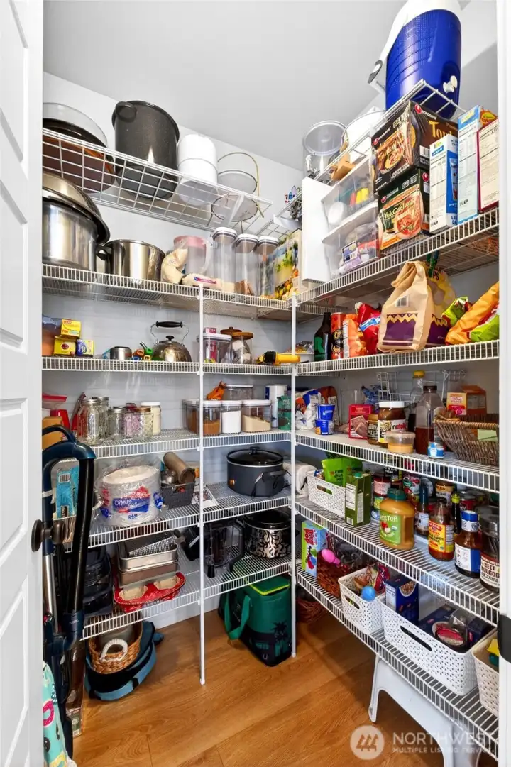 Large walk-in pantry with ample shelving. Large walk-in pantry with ample shelving.
