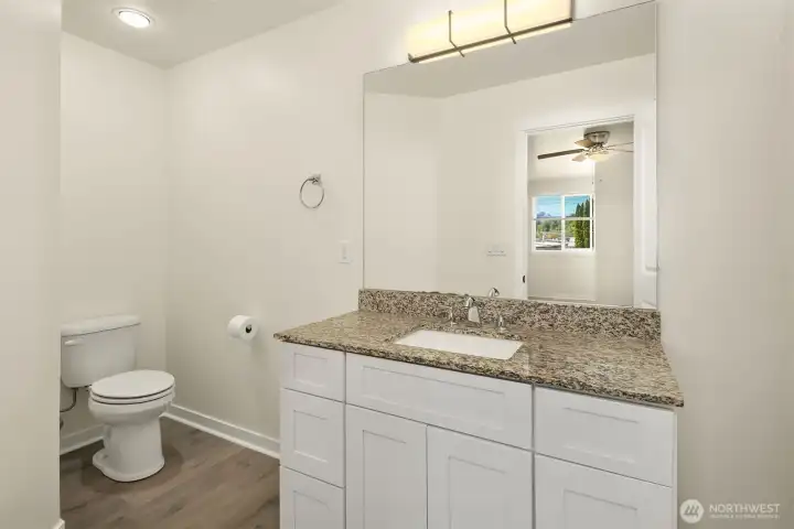 Primary bathroom with granite counters and walk in shower