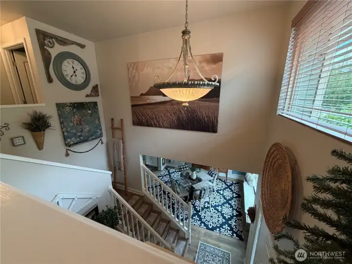 A dramatic two-story entry and open landing create impressive sightlines and architectural character, enhancing the home's spacious feel.