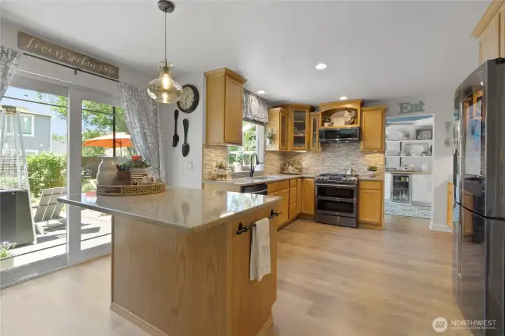 Designed for effortless living and entertaining, the kitchen opens directly to the outdoor living space, creating a seamless flow between meal preparation, dining, and gathering with family and friends.