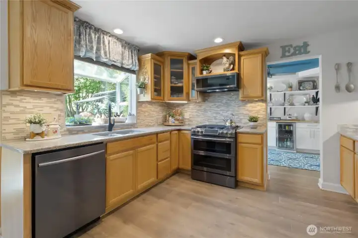 Natural light fills the kitchen, while the garden window offers peaceful views of the beautifully landscaped backyard—bringing the outdoors in throughout the day.