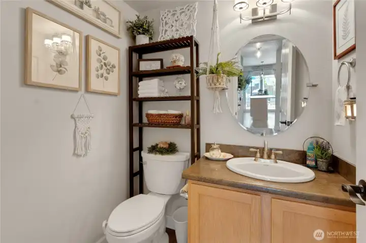 Even the main-floor powder room reflects the home's thoughtful design, offering convenience for guests and stylish finishes that complement the home's warm and welcoming feel.
