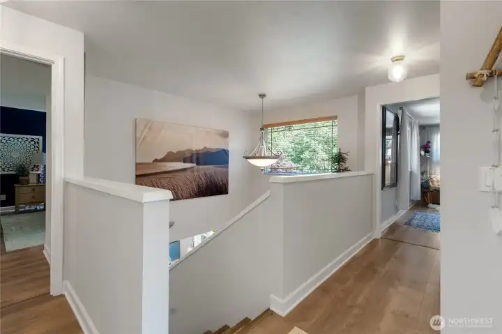 The open upper-level landing enhances the home's spacious feel while allowing natural light to flow throughout the second floor.