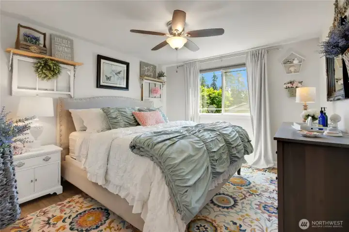 Generous proportions allow this secondary bedroom to comfortably accommodate larger furniture while still feeling bright, open, and inviting. Yes, that's a king size bed, an 8-drawer dresser, and night stand with room to spare.