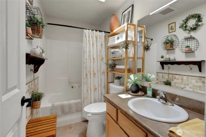 Natural light pours in through the skylight, creating a bright and inviting guest bathroom designed for everyday comfort and convenience.